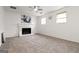 Bright living room featuring a fireplace, carpet floors, ceiling fan, and natural light at 4651 Garden Hills Dr, Stone Mountain, GA 30083