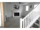 Cozy living room with a fireplace and plush carpeting next to white stair railing at 4651 Garden Hills Dr, Stone Mountain, GA 30083