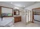 Bright bathroom with a large tub, separate shower, and wood-framed mirror at 715 Branchview Ct, Mcdonough, GA 30252
