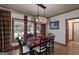 Inviting dining room featuring a large table with seating, wood floors, and large windows overlooking the backyard at 715 Branchview Ct, Mcdonough, GA 30252