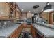Charming kitchen with stainless steel appliances, custom wood cabinets, granite counters, and a tile backsplash at 715 Branchview Ct, Mcdonough, GA 30252