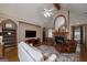 Cozy living room featuring a fireplace, built-in shelving, hardwood floors, and comfortable seating arrangement at 715 Branchview Ct, Mcdonough, GA 30252