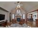 Cozy living room with a fireplace, vaulted ceilings, and hardwood floors at 715 Branchview Ct, Mcdonough, GA 30252
