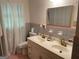 Bathroom with a dual sink vanity, vintage tile, and ample natural light at 1470 Dunn Rd, Cumming, GA 30040