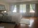 Cozy bedroom with hardwood floors, a large bed, and natural light from the windows at 1470 Dunn Rd, Cumming, GA 30040