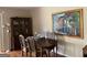 Elegant dining room with a beautiful painting, classic furniture, and natural light at 1470 Dunn Rd, Cumming, GA 30040