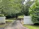 Long driveway leading to a white gated entrance at 1470 Dunn Rd, Cumming, GA 30040