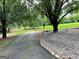 Long driveway surrounded by mature trees and landscaping at 1470 Dunn Rd, Cumming, GA 30040