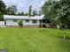 Backyard view of the property with white siding, well-manicured lawn, and a charming staircase at 1470 Dunn Rd, Cumming, GA 30040