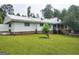 Ranch home featuring a metal roof, brick accents, and a well-manicured lawn at 1470 Dunn Rd, Cumming, GA 30040