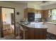 Open kitchen featuring an island with bar seating and views of an adjacent room, great for entertaining at 1470 Dunn Rd, Cumming, GA 30040