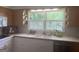 Charming kitchen with natural light, window, and neutral tones with modern appliances and ample countertop space at 1470 Dunn Rd, Cumming, GA 30040