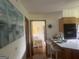 Another view of the kitchen with island and bar stools that leads to the adjacent room with nautical themed art at 1470 Dunn Rd, Cumming, GA 30040