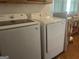 Modern laundry room with side-by-side washer and dryer, offering convenience and efficiency for household chores at 1470 Dunn Rd, Cumming, GA 30040