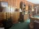 Cozy living room features wood paneling, fireplace, and a built-in desk area at 1470 Dunn Rd, Cumming, GA 30040