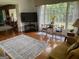 Bright living room features hardwood floors, large windows, and comfortable seating area at 1470 Dunn Rd, Cumming, GA 30040