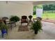 Covered patio with wicker furniture and potted plants at 1470 Dunn Rd, Cumming, GA 30040