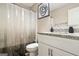 A bathroom with modern fixtures and a minimalist design, complemented by a neutral-toned shower curtain at 634 Gardner Rd, Stockbridge, GA 30281