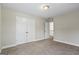 Empty bedroom featuring plush carpeting, an ample closet, and abundant natural light for a cozy atmosphere at 634 Gardner Rd, Stockbridge, GA 30281