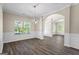Open dining area with modern chandelier, paneled walls, wood flooring and lots of windows for natural light at 634 Gardner Rd, Stockbridge, GA 30281