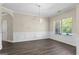 Dining room with modern lighting, paneled walls, wood flooring and a view to the living room at 634 Gardner Rd, Stockbridge, GA 30281