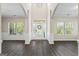 Spacious foyer with soaring ceilings, wood floors, white wainscoting, and natural light from surrounding windows at 634 Gardner Rd, Stockbridge, GA 30281