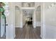 Bright and open foyer with wood flooring, white wainscoting, and arched doorways leading to living areas at 634 Gardner Rd, Stockbridge, GA 30281