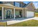 Charming front porch with white columns, seating, and a decorative wreath on the front door at 634 Gardner Rd, Stockbridge, GA 30281