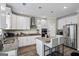 Modern kitchen boasts white cabinetry, granite countertops, and stainless steel appliances at 634 Gardner Rd, Stockbridge, GA 30281