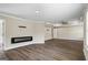 Spacious living room featuring wood-look floors, fireplace, and ceiling fan at 634 Gardner Rd, Stockbridge, GA 30281