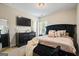Main bedroom with a plush bed, decorative pillows, modern dresser, and stylish decor at 634 Gardner Rd, Stockbridge, GA 30281