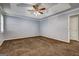 Large bedroom with tray ceiling, ceiling fan, and neutral paint at 113 Elmwood Dr, Hampton, GA 30228