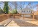 Backyard featuring a wooden deck with railings and view to garage with stairs and driveway at 1450 Elizabeth Ln, East Point, GA 30344