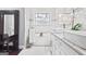 A luxurious bathroom showcasing a soaking tub, dual vessel sinks, and marble flooring with a view to the outside at 1450 Elizabeth Ln, East Point, GA 30344