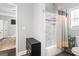Bathroom with a shower-tub combination, dark vanity, neutral wall and a window at 1450 Elizabeth Ln, East Point, GA 30344