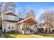A cozy home with a welcoming porch, complemented by lush landscaping and mature trees at 1450 Elizabeth Ln, East Point, GA 30344