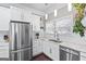 Bright, clean kitchen featuring stainless steel appliances, white cabinets, and elegant counter tops at 1450 Elizabeth Ln, East Point, GA 30344