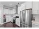 Bright kitchen features white cabinets, stainless steel appliances, dark hardwood floors, and recessed lighting at 1450 Elizabeth Ln, East Point, GA 30344