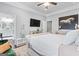 A serene bedroom with a tufted bed, a TV, and a decorative horse art, providing a relaxing retreat at 1450 Elizabeth Ln, East Point, GA 30344