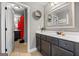 Bathroom with a large mirror, dark cabinets, and white countertop at 240 Sturry Dr, Mcdonough, GA 30252