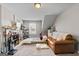 Spacious room featuring a leather couch and lots of shelving and decor at 240 Sturry Dr, Mcdonough, GA 30252