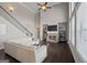 Open-concept living space with fireplace, tall windows, and hardwood floors at 240 Sturry Dr, Mcdonough, GA 30252