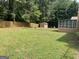 Expansive backyard featuring a storage shed, providing ample space for outdoor activities and storage at 416 Winterwood Dr, Stockbridge, GA 30281