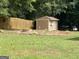 Large backyard featuring a storage shed and a lush green lawn, perfect for outdoor activities and relaxation at 416 Winterwood Dr, Stockbridge, GA 30281
