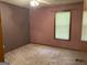Bedroom with mauve walls, light colored carpet, window and ceiling fan at 416 Winterwood Dr, Stockbridge, GA 30281