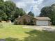 Charming home with a well-manicured lawn, mature trees, and a two-car garage at 416 Winterwood Dr, Stockbridge, GA 30281