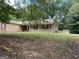 Ranch style home with front porch and mature trees shading the lawn at 416 Winterwood Dr, Stockbridge, GA 30281