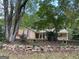 Charming home featuring red shutters, covered porch and a rock retaining wall at 416 Winterwood Dr, Stockbridge, GA 30281