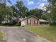 Classic ranch-style home with attached garage, driveway, and mature trees on a grassy lot at 416 Winterwood Dr, Stockbridge, GA 30281