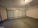 Spacious garage with an overhead light fixture ready to park your vehicle and store your belongings at 416 Winterwood Dr, Stockbridge, GA 30281